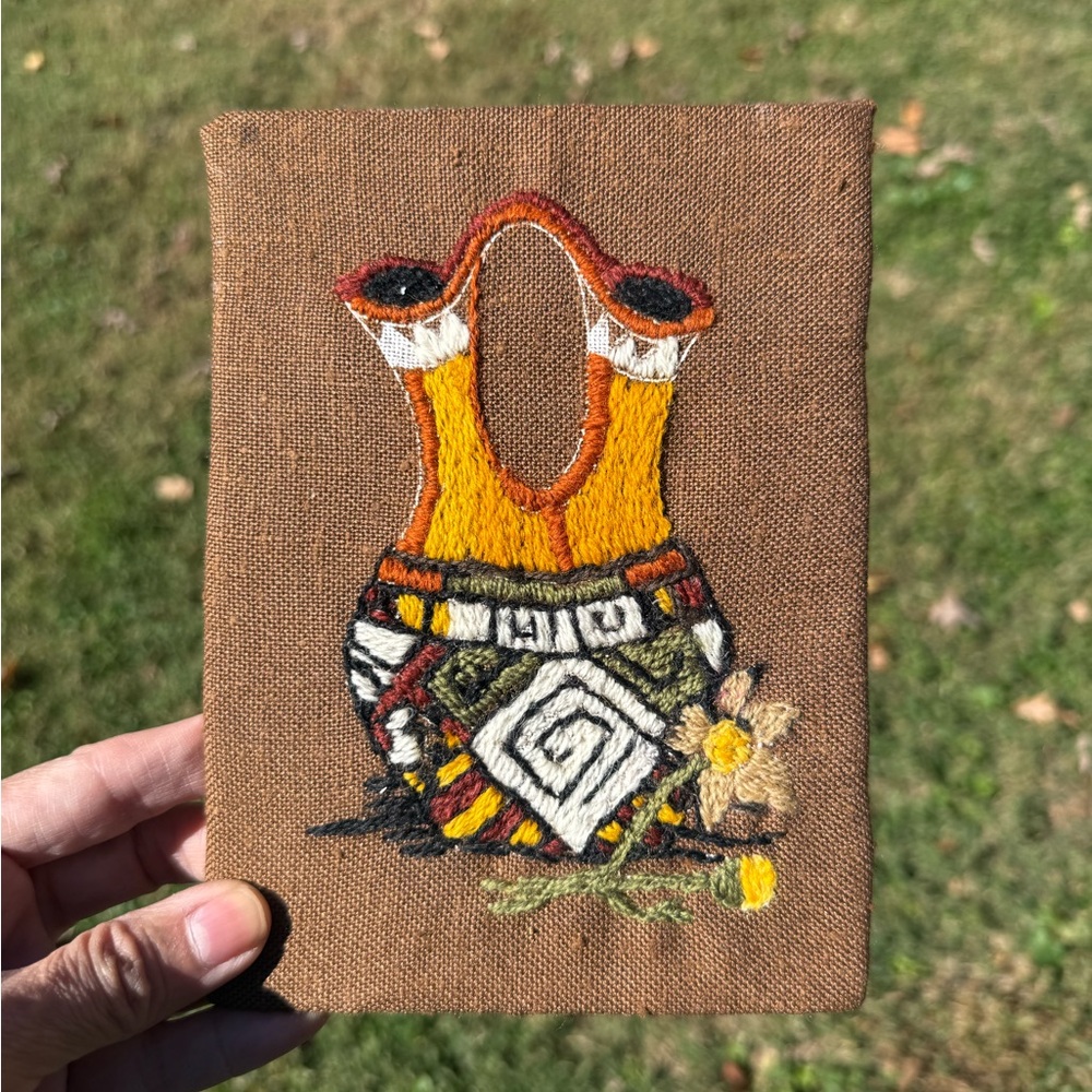 Vintage embroidered piece of art depicting a Native American wedding vase.